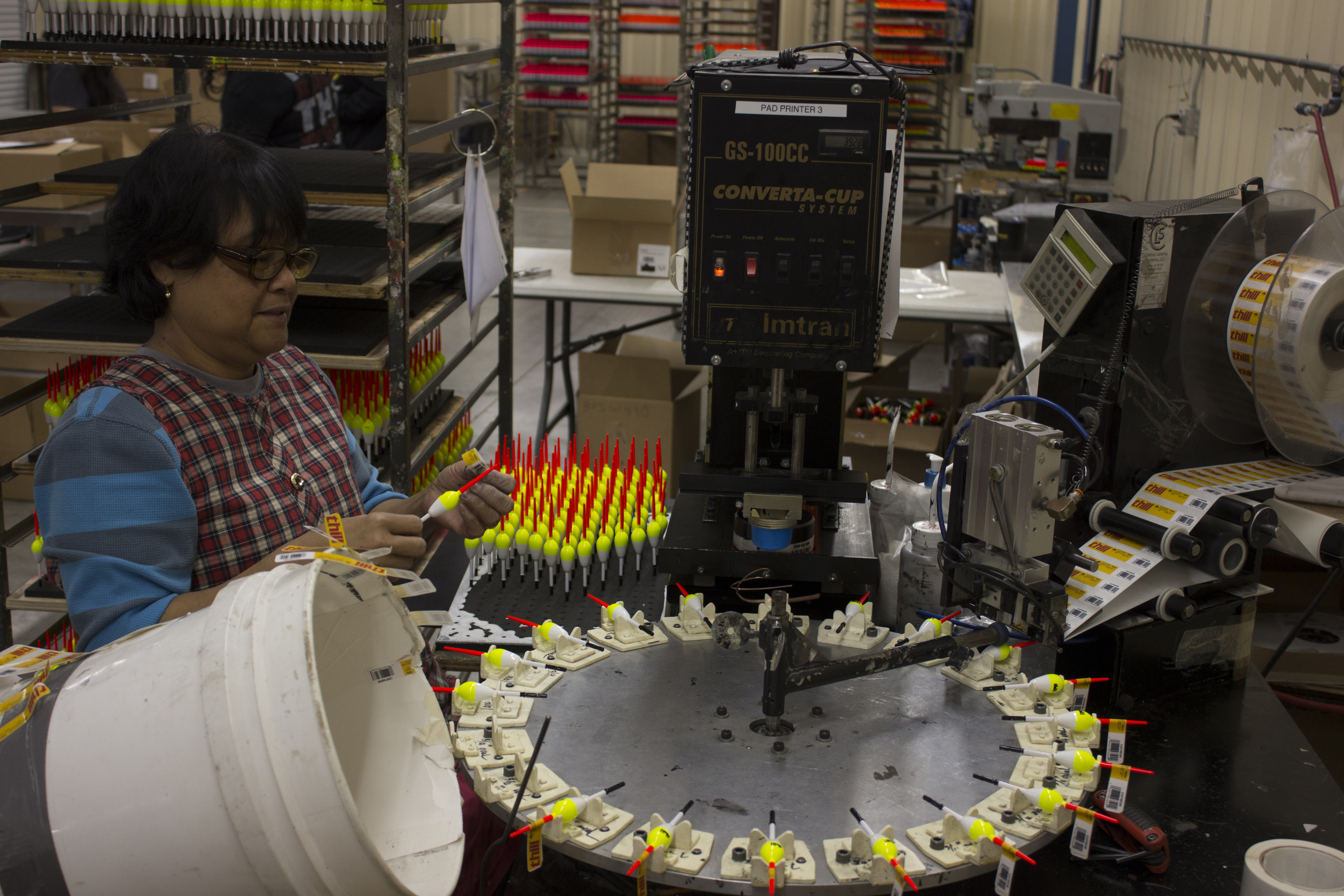 An employee at a tackle manufacturer packs floats for shipment.