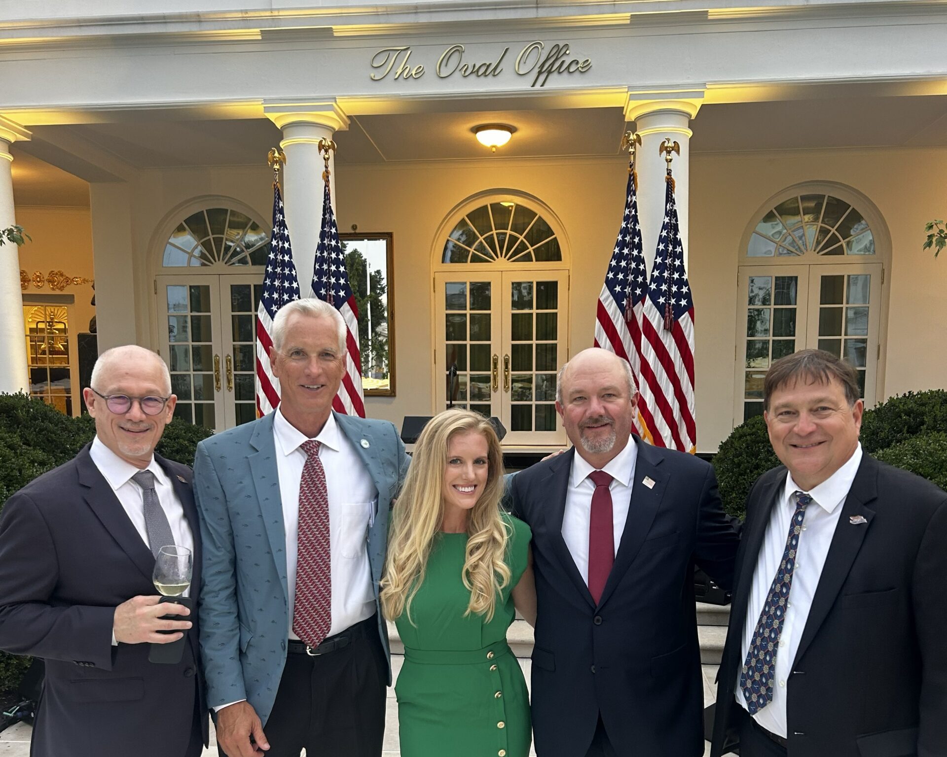 industry leaders in front of the White House Oval Office